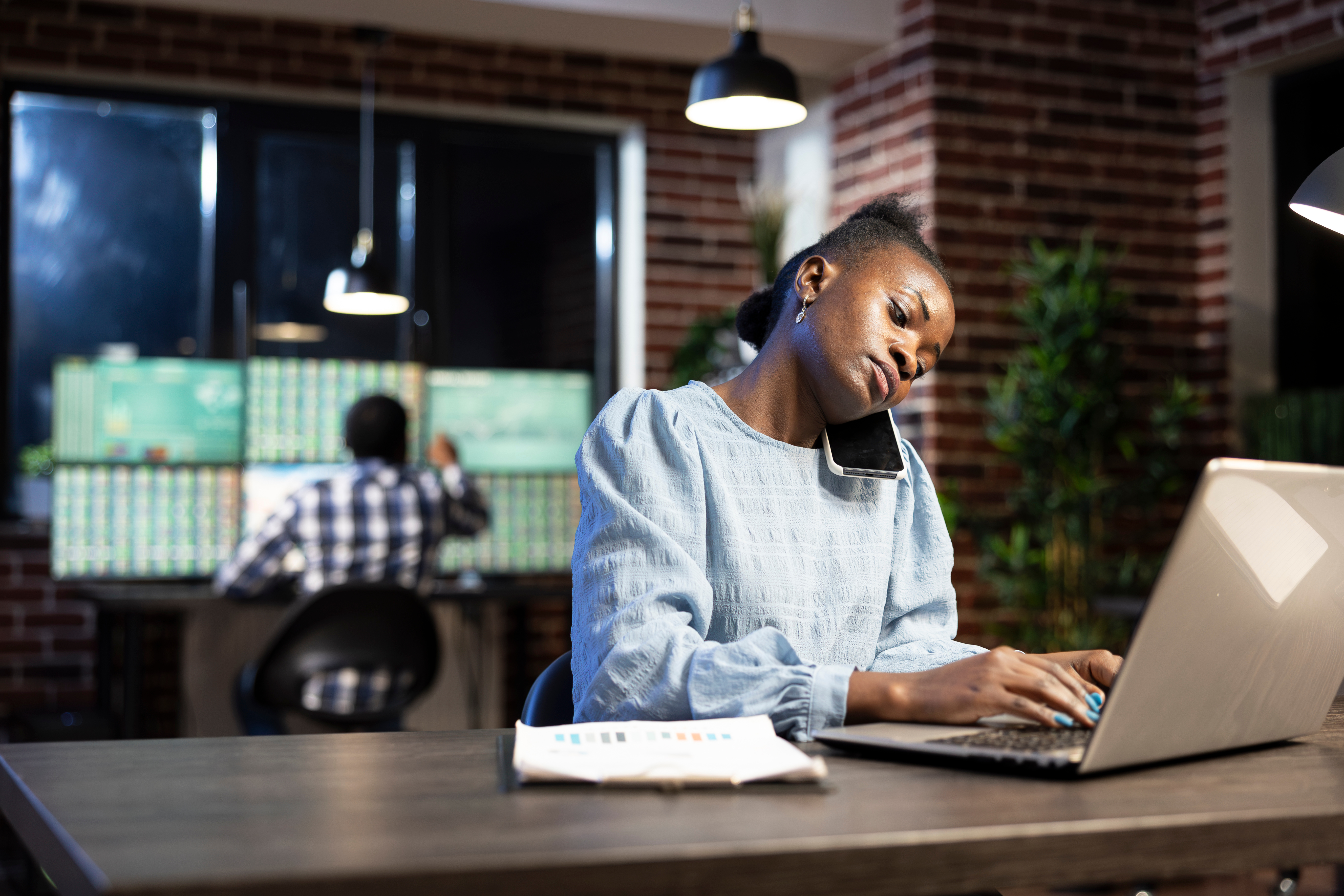 Woman working on a computer at a desk.
